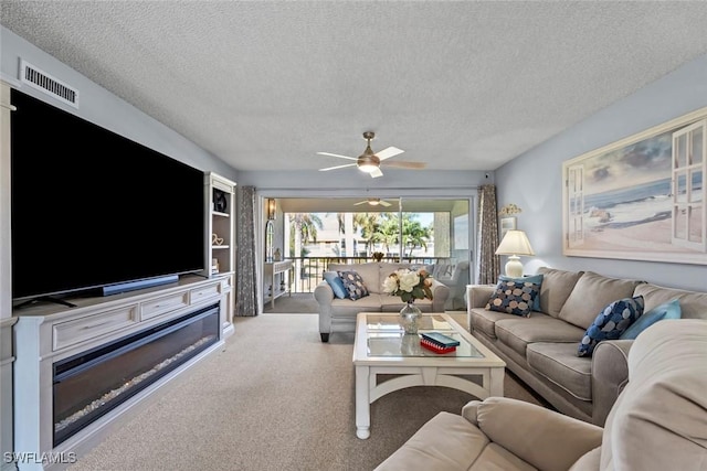 living room with a textured ceiling and ceiling fan