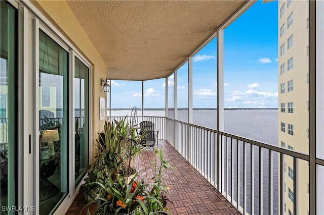 unfurnished sunroom with a water view