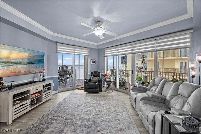 living room featuring ceiling fan and crown molding