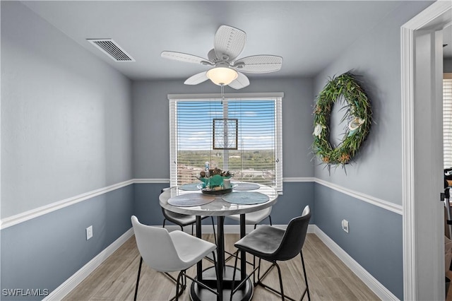 dining area with ceiling fan and light hardwood / wood-style floors