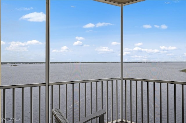 unfurnished sunroom featuring a water view