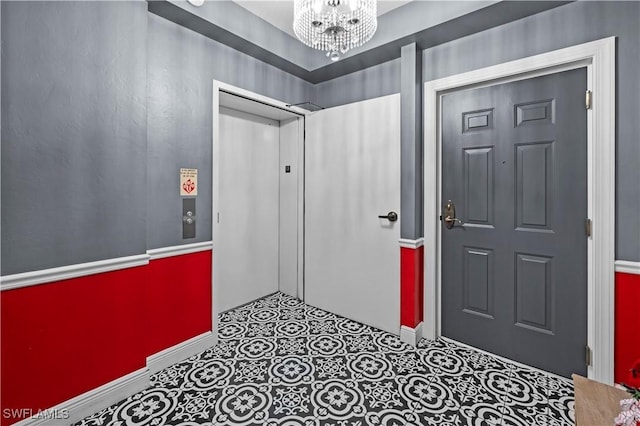 foyer with a chandelier