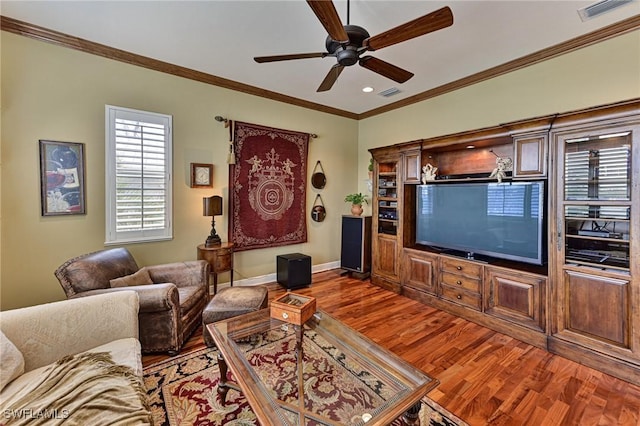 living room featuring crown molding, ceiling fan, and wood-type flooring