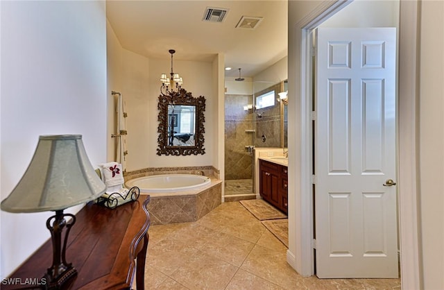 bathroom with independent shower and bath, vanity, tile patterned flooring, and an inviting chandelier