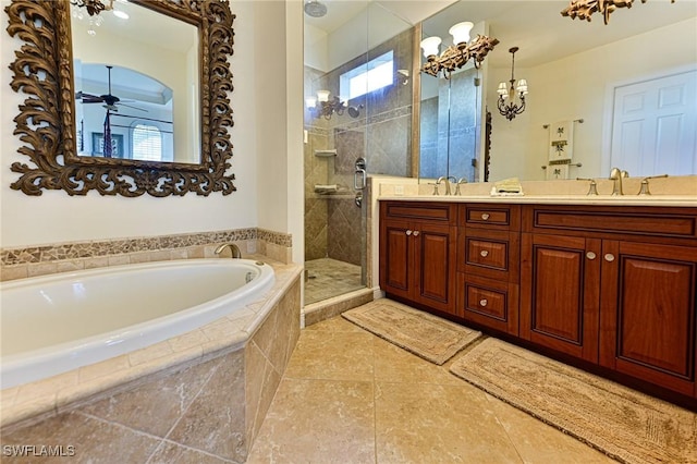 bathroom with ceiling fan, vanity, and separate shower and tub