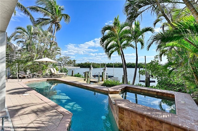 view of swimming pool featuring an in ground hot tub, a water view, and a dock