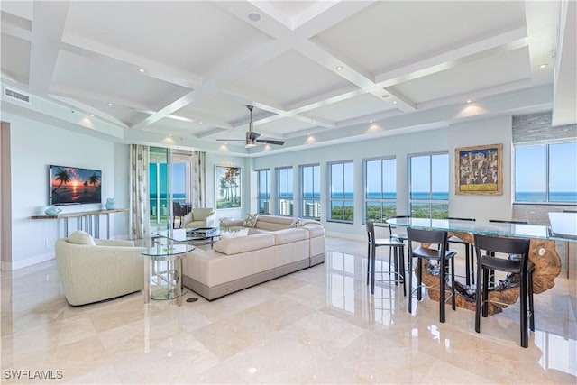 living room with coffered ceiling, ceiling fan, beamed ceiling, and a water view