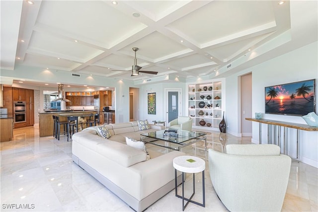 living room with beam ceiling, built in features, and ceiling fan