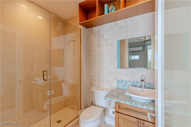 bathroom featuring tile walls, vanity, an enclosed shower, decorative backsplash, and toilet