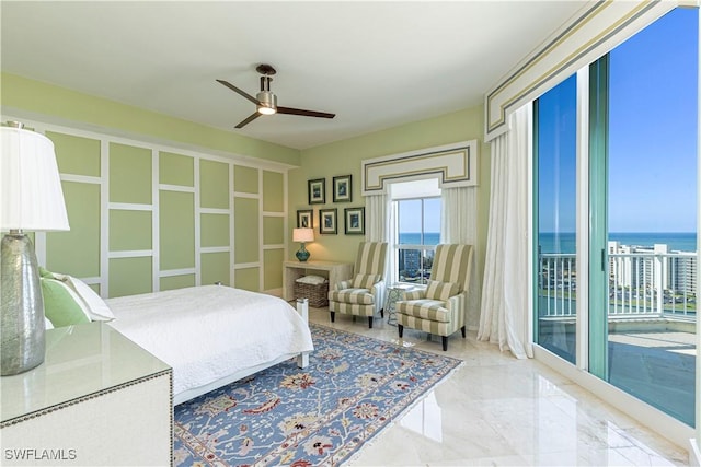 bedroom with a water view, access to exterior, and ceiling fan