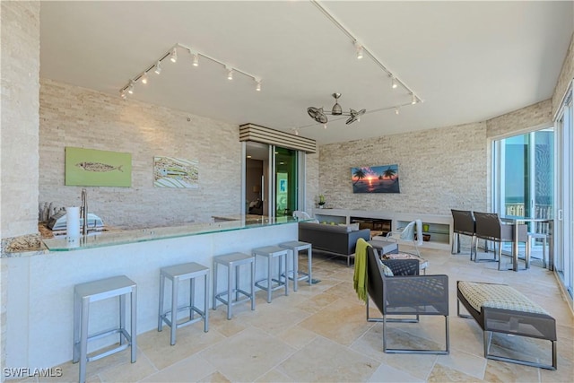 view of patio / terrace with ceiling fan, an outdoor hangout area, and an outdoor bar