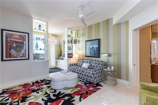 living room featuring ceiling fan with notable chandelier and built in features