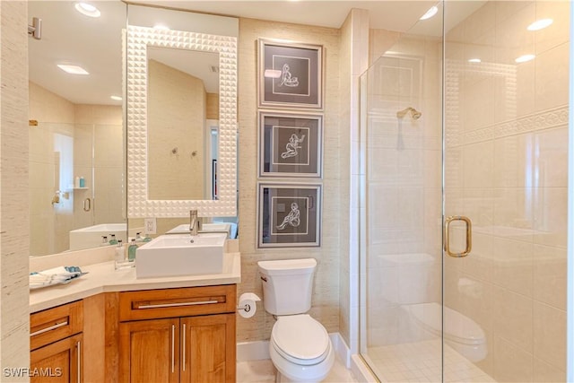 bathroom with walk in shower, vanity, and toilet