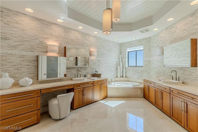 bathroom featuring vanity, tile walls, and tiled tub