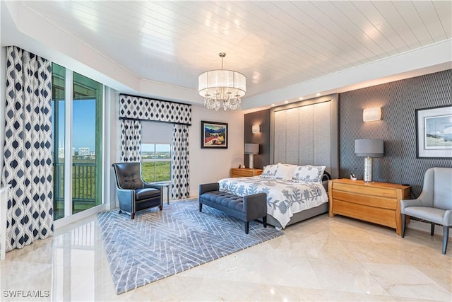 bedroom featuring access to outside and a chandelier