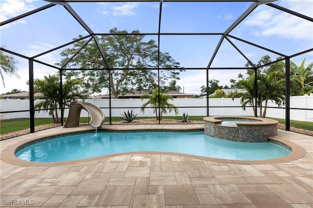 view of swimming pool featuring an in ground hot tub, a patio, glass enclosure, and a water slide