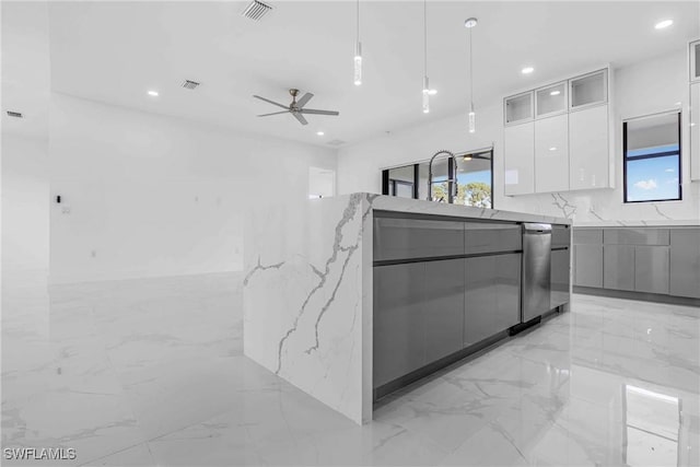 kitchen featuring ceiling fan, dishwasher, light stone counters, decorative light fixtures, and white cabinets