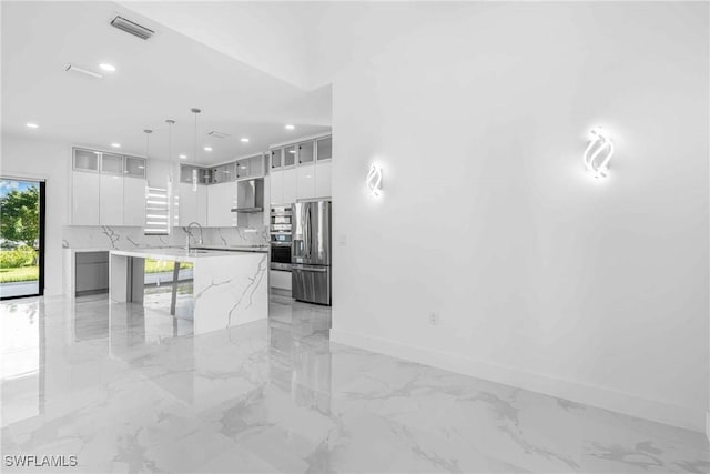 kitchen with white cabinetry, a large island, stainless steel fridge with ice dispenser, and wall chimney range hood