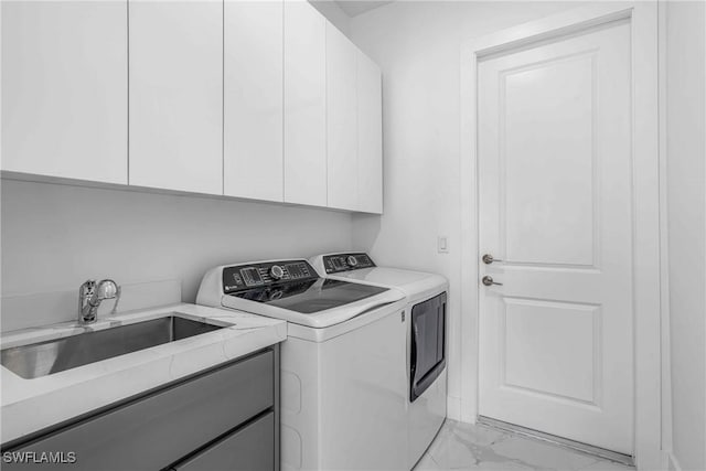 washroom featuring cabinets, independent washer and dryer, and sink