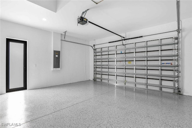 garage with a garage door opener and electric panel