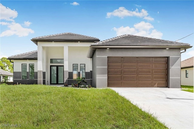 exterior space featuring a garage and a front lawn