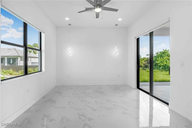 unfurnished room with a wealth of natural light and ceiling fan