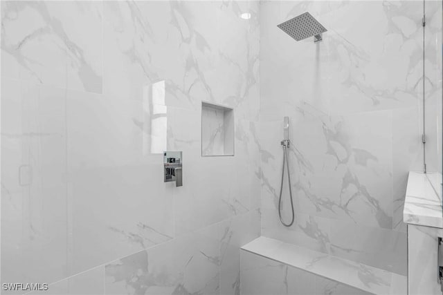 bathroom with a tile shower