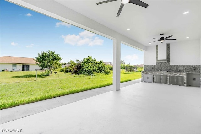 view of patio with ceiling fan and area for grilling