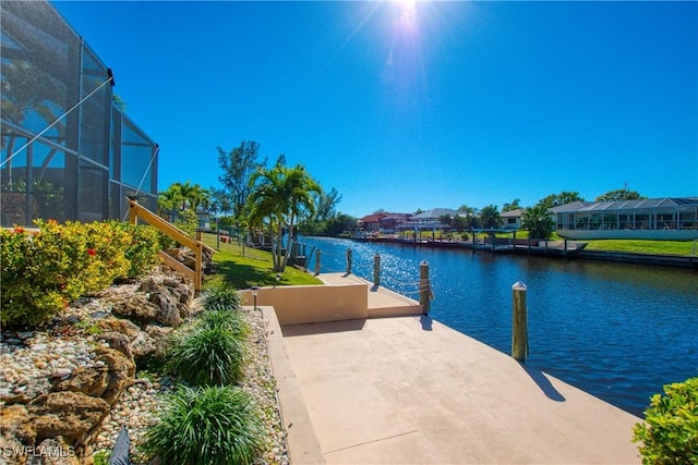 exterior space with a lanai, a dock, and a water view