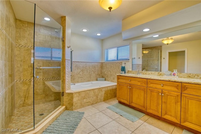 bathroom with vanity, shower with separate bathtub, and tile patterned floors