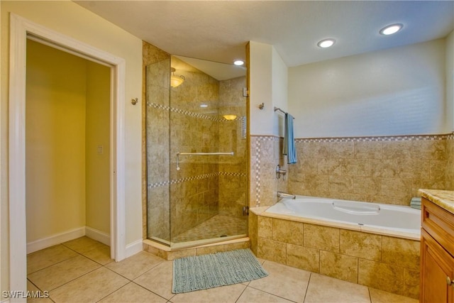 bathroom featuring vanity, shower with separate bathtub, and tile patterned flooring