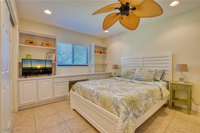 bedroom with built in desk, ceiling fan, and light tile patterned floors