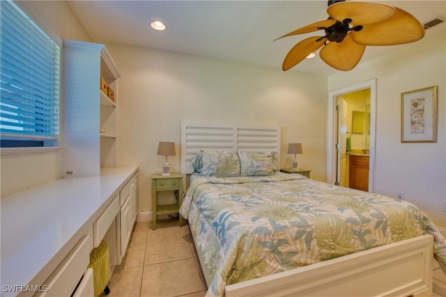 bedroom with light tile patterned floors, ceiling fan, and ensuite bath