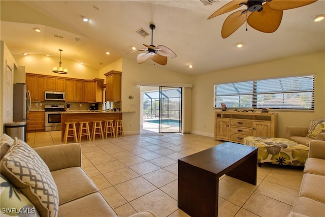 tiled living room featuring ceiling fan and lofted ceiling