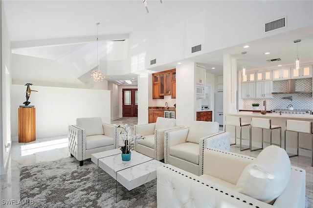 living room with high vaulted ceiling