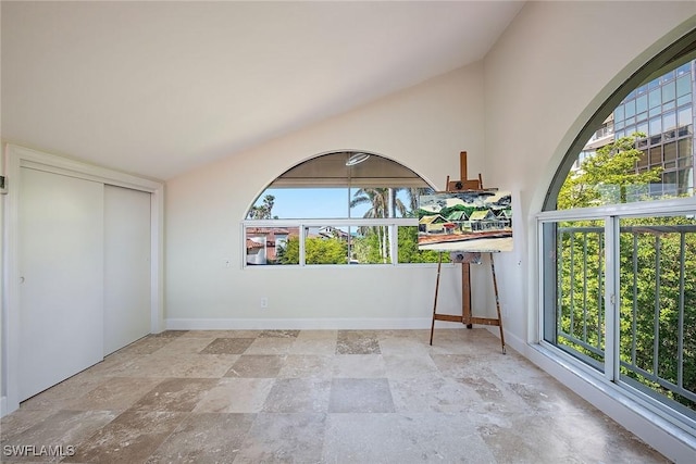 unfurnished sunroom with lofted ceiling