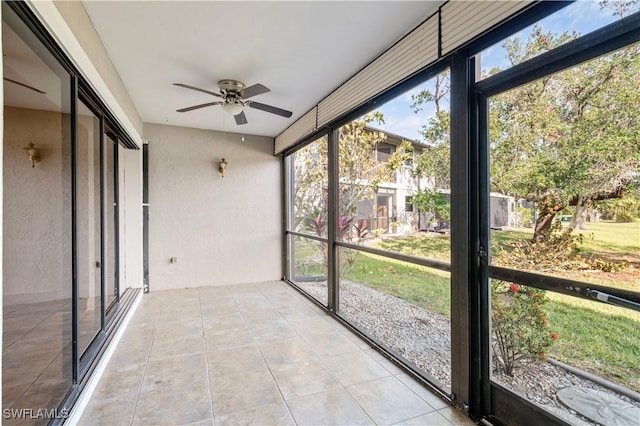 unfurnished sunroom with ceiling fan