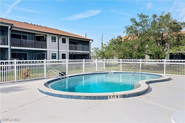 view of swimming pool with a patio