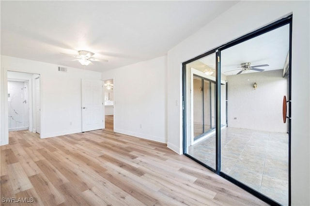 unfurnished room featuring ceiling fan and light hardwood / wood-style floors