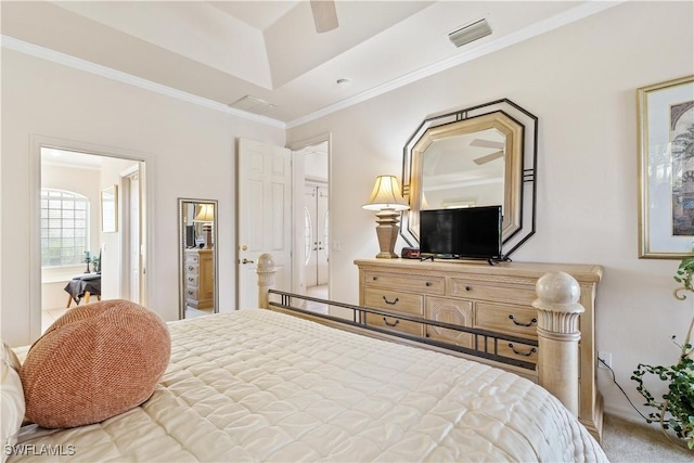 bedroom featuring a raised ceiling, ceiling fan, crown molding, and carpet