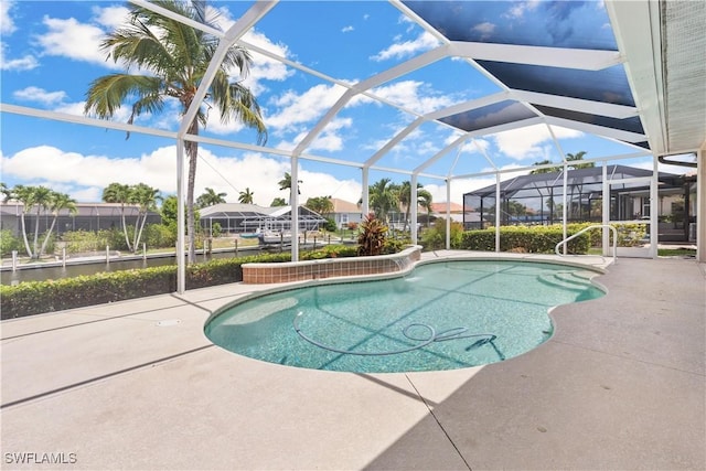 view of swimming pool with a patio area and a lanai