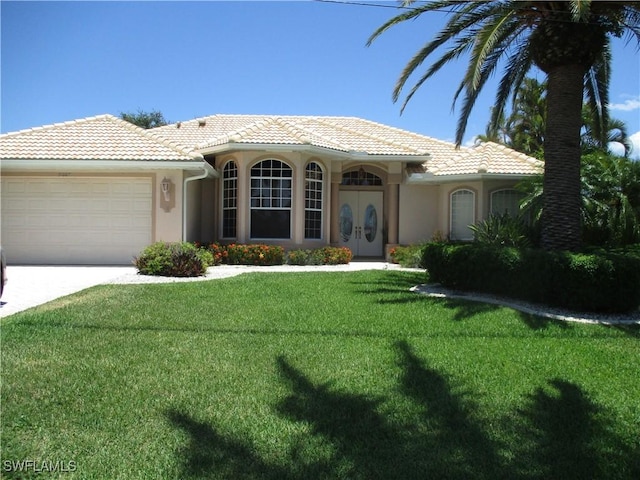 view of front facade featuring a garage and a front lawn