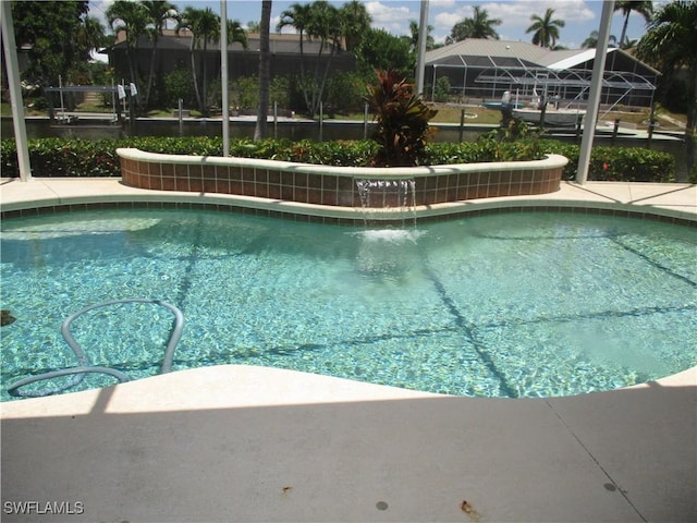 view of swimming pool with glass enclosure