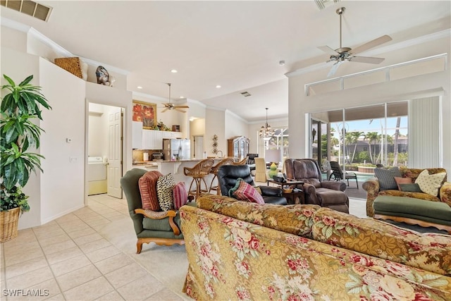 living room featuring washer / clothes dryer, ceiling fan, light tile patterned flooring, and ornamental molding