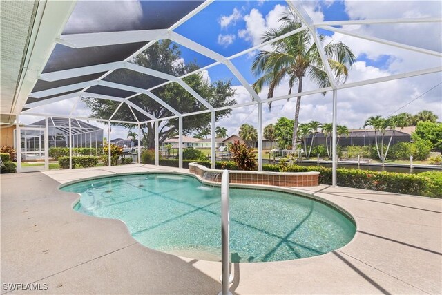 view of pool with a patio and a lanai