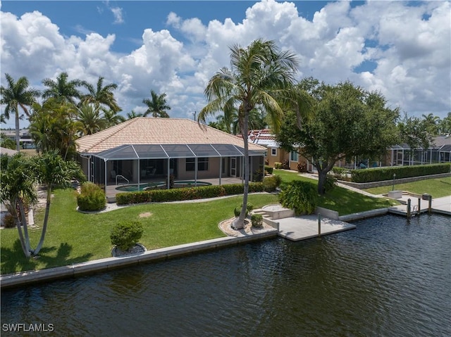 back of house featuring a lawn, glass enclosure, and a water view