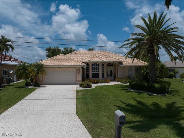 mediterranean / spanish-style house with a garage and a front yard