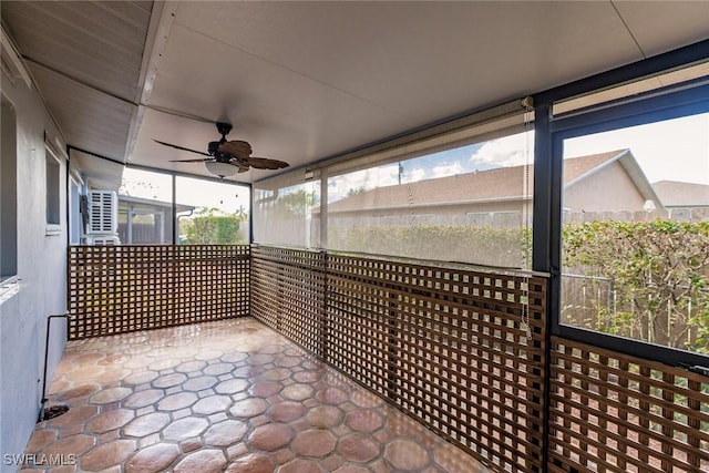 unfurnished sunroom with ceiling fan and a healthy amount of sunlight