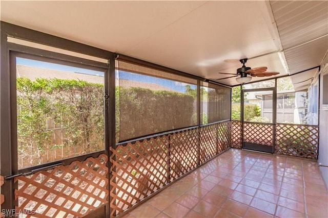 unfurnished sunroom with ceiling fan and a healthy amount of sunlight