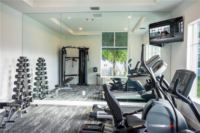 gym with a raised ceiling